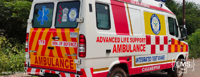 advanced-life-support-ambulance-with-red-and-white-checkered-pattern-and-integrated-test-range-logo-parked-outdoors