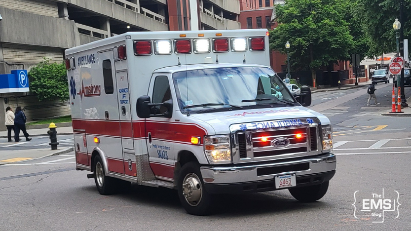 american-ambulance-with-flashing-lights-driving-through-a-city-street-during-an-emergency-response