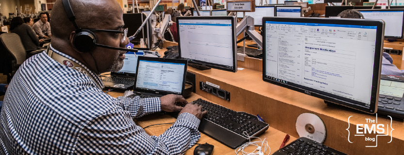emergency-dispatch-operator-working-at-control-center-with-multiple-monitors