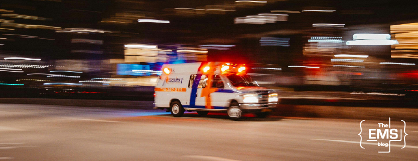 white-ambulance-driving-at-night-with-its-red-emergency-warning-lights-flashing